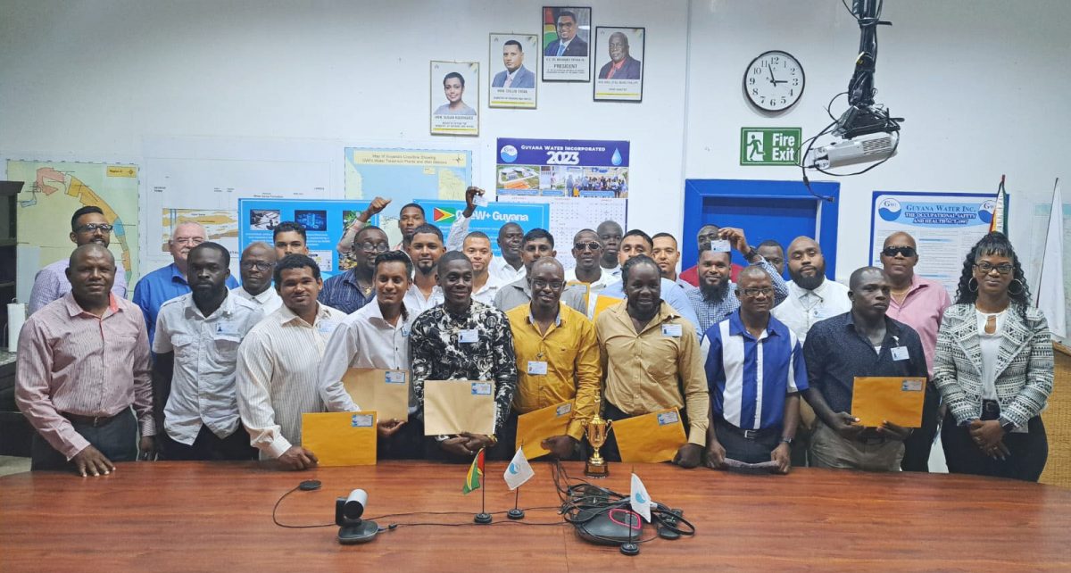 The plant operators, who recently graduated, with senior officials of GWI  (GWI photo)
