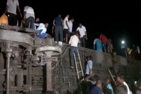 People try to escape from toppled compartments, following the deadly collision of two trains, in Balasore, India June 2, 2023, in this screen grab obtained from a video. ANI/Reuters TV via REUTERS