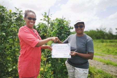 Jaikumarie Persaud (right) receiving her certificate from Dr. Gillian Smith, FAO Representative