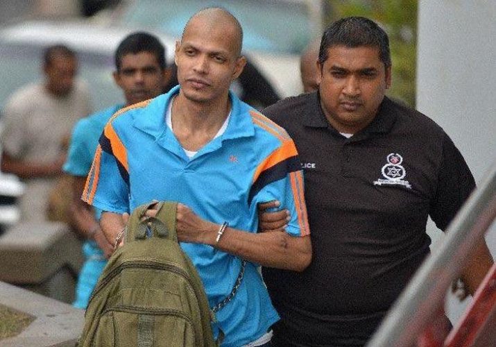 Rapist Jules John Arjoon is escorted to the San Fernando High Court in April on the charges of rape, kidnapping and robbery against three women.—Photo: DEXTER PHILIP