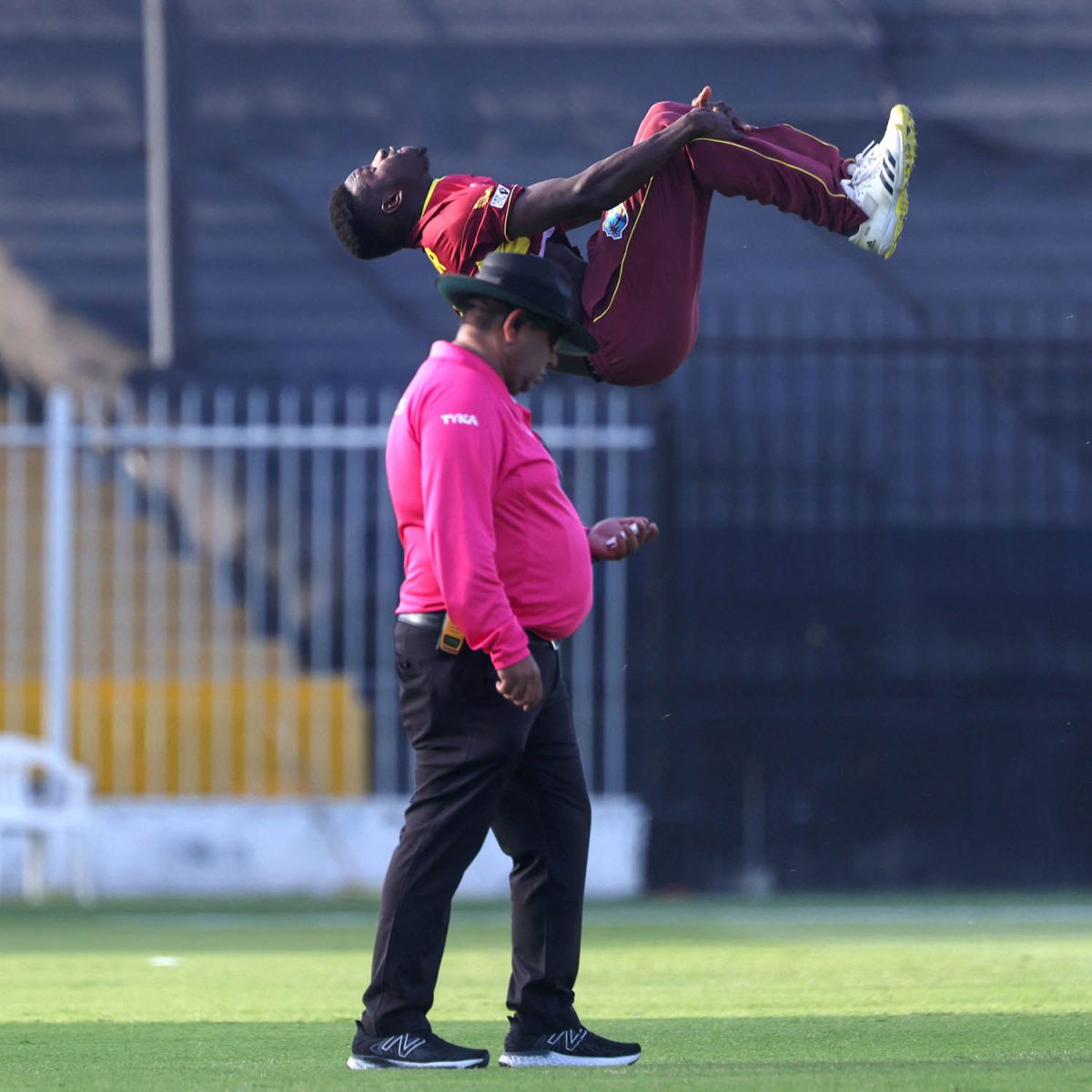 West Indies off-spinner Kevin Sinclair is head over heels with joy after capturing another wicket during his Man of the Match bowling performance of 4-24 against the United Arab Emirates yesterday.