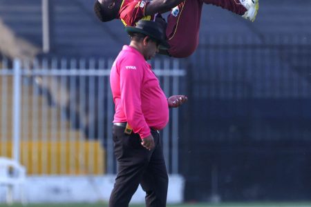 West Indies off-spinner Kevin Sinclair is head over heels with joy after capturing another wicket during his Man of the Match bowling performance of 4-24 against the United Arab Emirates yesterday.