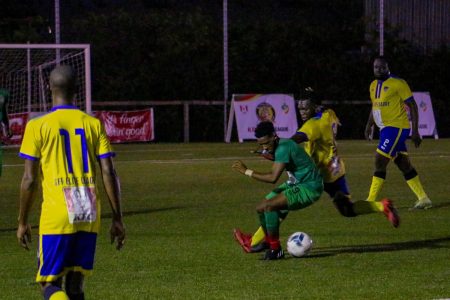 Chris Macey of the GDF trying to escape the pursuit of the Milerock defender during their encounter in the KFC Elite League.