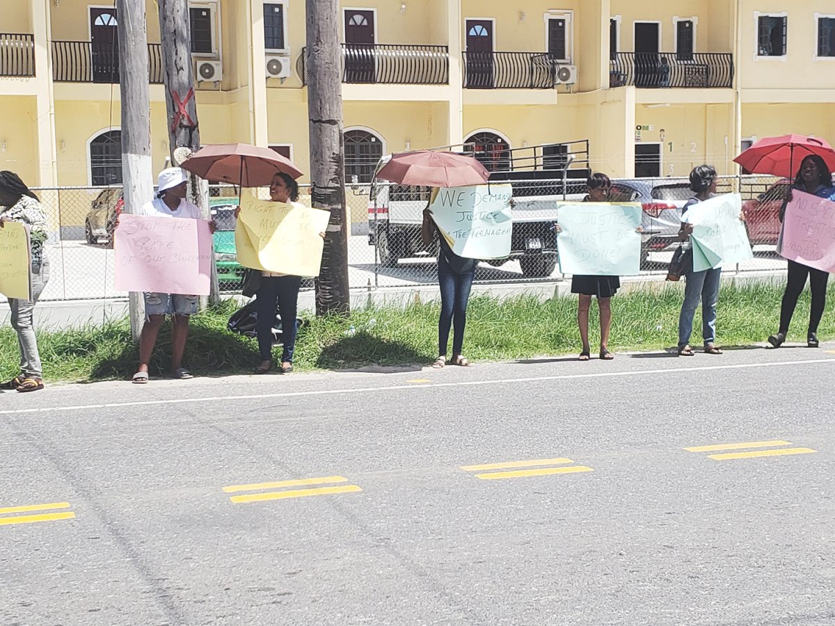 Members of Red Thread protesting in front of the Guyana Police Force Headquarters 