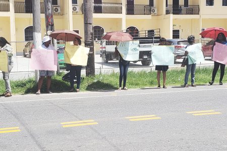 Members of Red Thread protesting in front of the Guyana Police Force Headquarters 