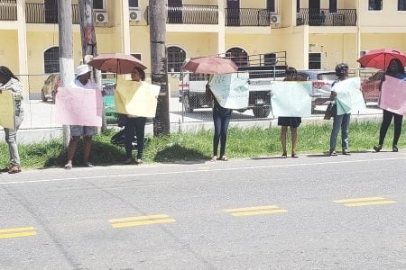 Members of Red Thread protesting in front of the Guyana Police Force Headquarters 