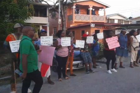 Residents and vendors protesting along the main access road to Plaisance village yesterday