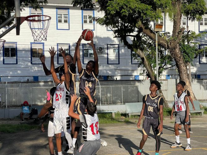 A scene from the Queen’s College (blue) and SB Combined matchup at the St. Stanislaus College Hard-court