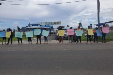 Red Thread protesters outside the Arthur Chung Conference Centre yesterday calling for legal representation for the complainant in the rape allegation against Minister of Local Government, Nigel Dharamlall. (Red Thread photo)