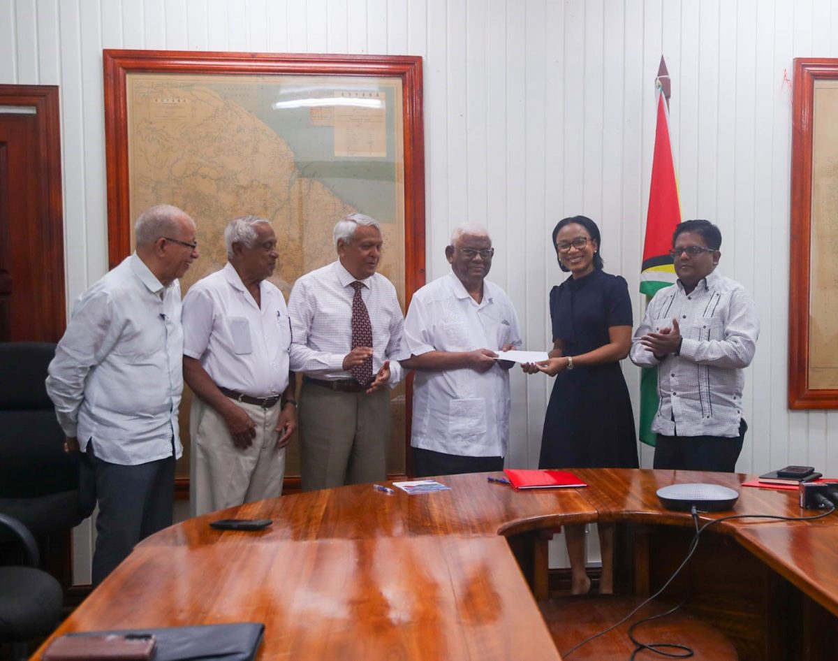 Minister of Tourism, Industry and Commerce Oneidge Walrond (second from right) and  Chairman of SBDF, Sattaur Gafoor (third from right)  with the loan document. Minister of Finance, Dr Ashni Singh is at right. (Ministry of Finance photo)