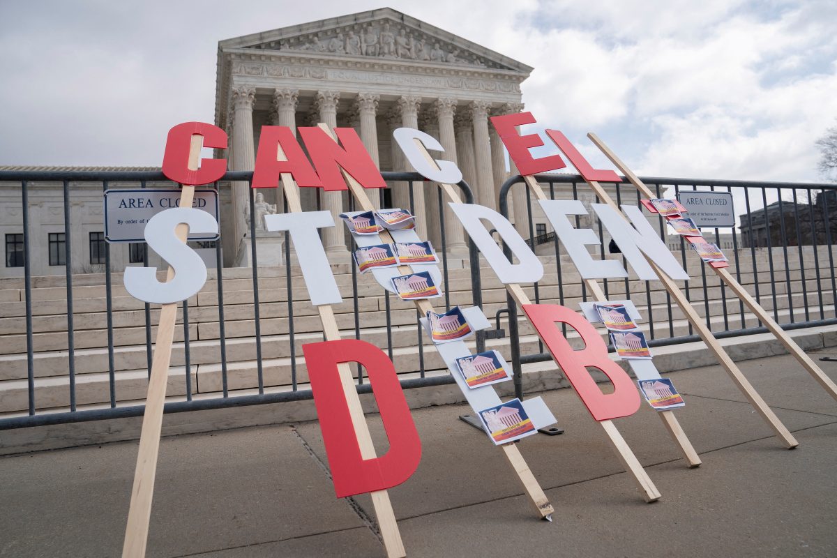 A sign calling for student loan debt relief is seen in front of the Supreme Court as the justices are scheduled to hear oral arguments in two cases involving President Joe Biden's bid to reinstate his plan to cancel billions of dollars in student debt in Washington, U.S., February 28, 2023. REUTERS/Nathan Howard/