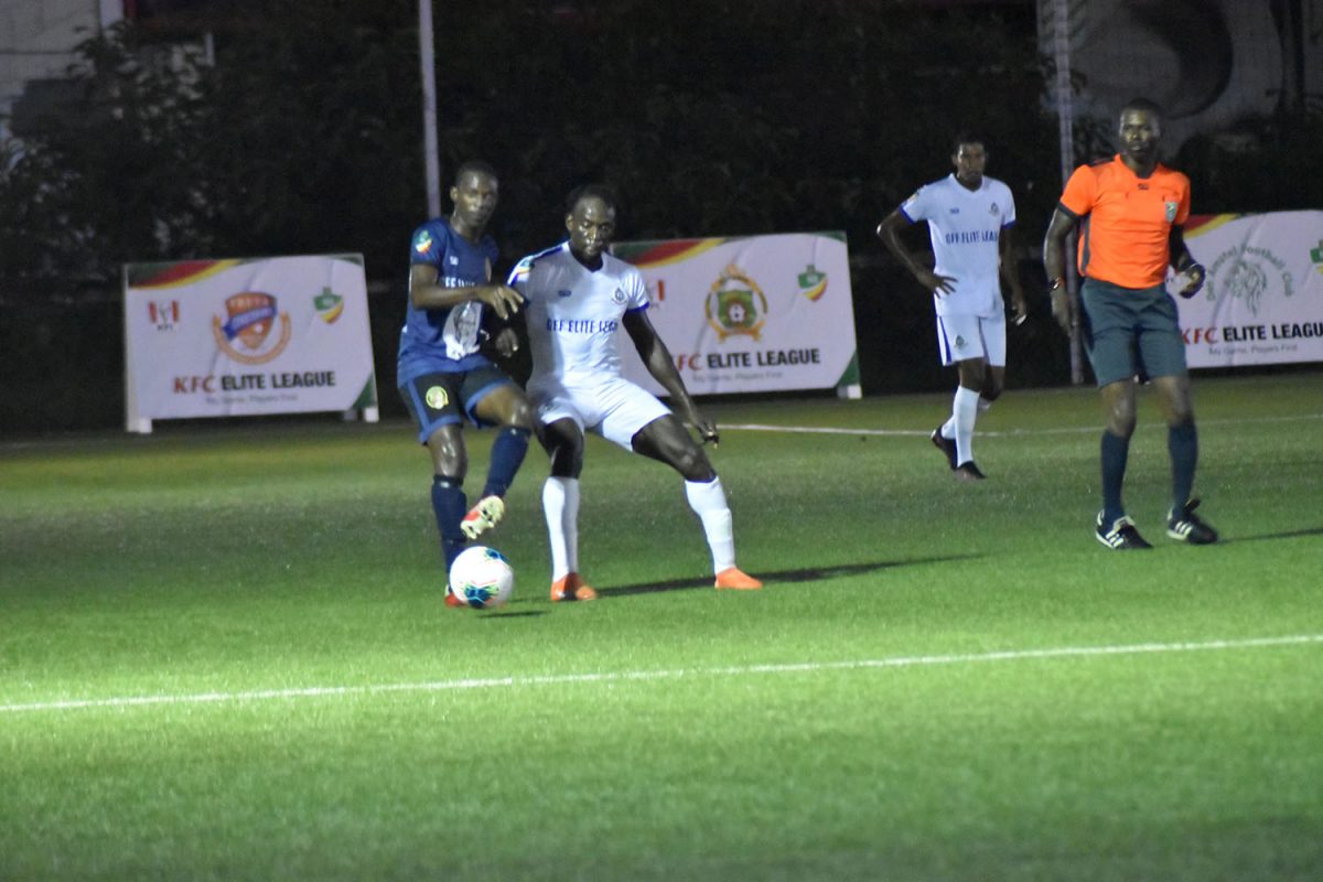 William Europe of Western Tigers (left) tussling with Sherwin Skeete of GPF for possession of the ball during their Elite League matchup.