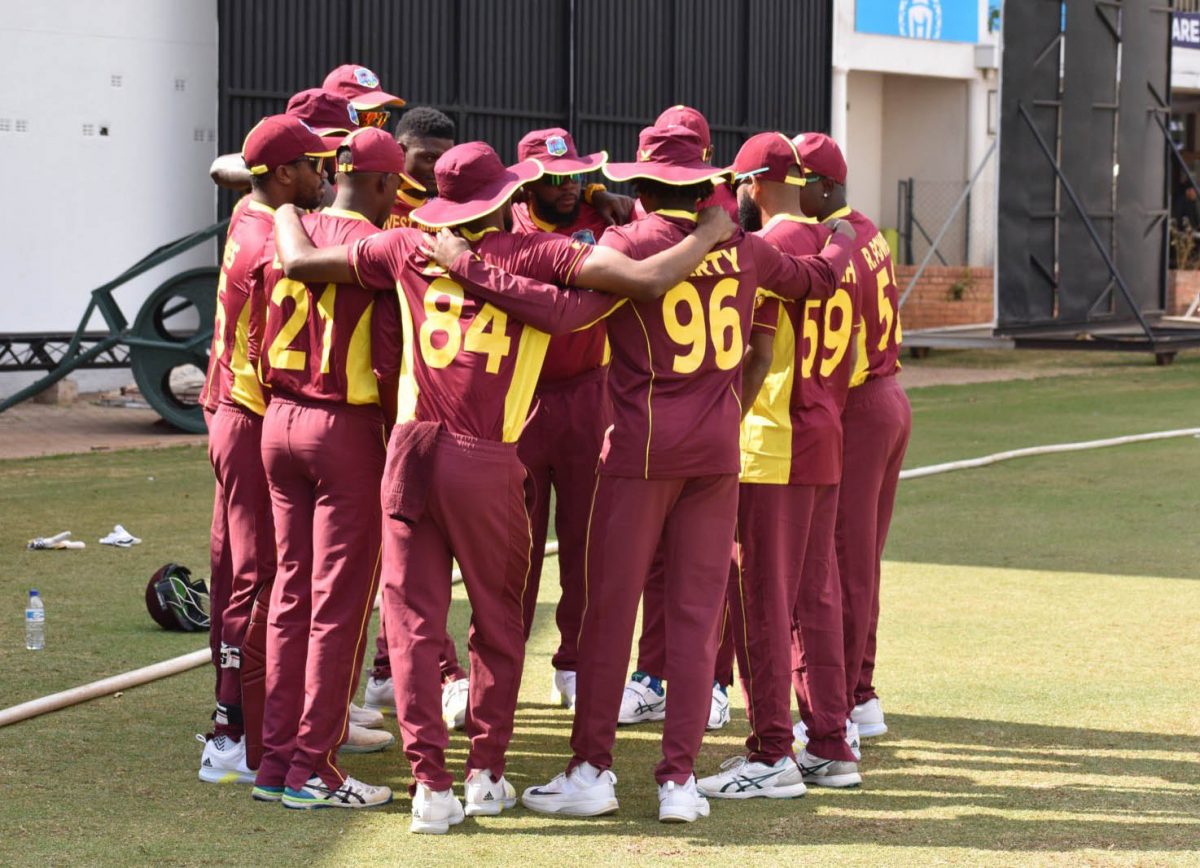 The West Indies players huddle at the fall of a Scotland player’s wicket