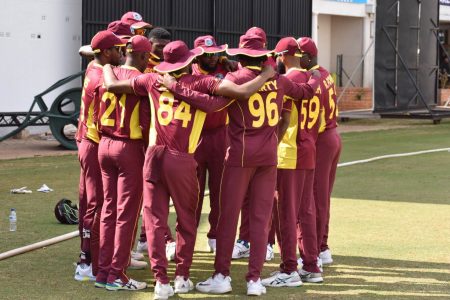 The West Indies players huddle at the fall of a Scotland player’s wicket