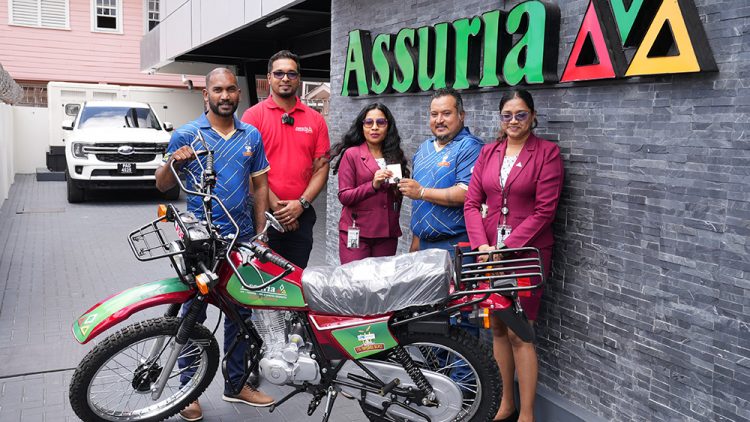 New Bike for MVP! From left: Co-Director of Kares One Guyana T10 Blast, Yusuf Ali, Sanjiv Nandlall (Assuria’s  Senior Supervisor forInformation and Communications Technology, and Marketing, Fiona Sooklall (Fire and General Insurance), Co-Director of Kares One Guyana T10 Blast, John Ramsingh and Nandanie Persaud (Marketing, Sales and Social Media Officer) at the company Church Street headquarters