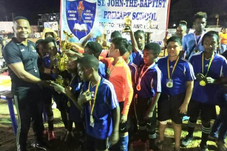 St. John the Baptist receiving the championship trophy after winning the Bartica Primary Schools Football Championship