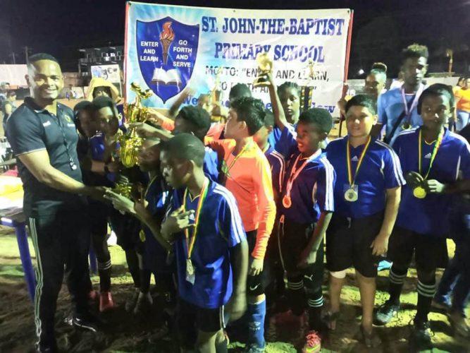 St. John the Baptist receiving the championship trophy after winning the Bartica Primary Schools Football Championship