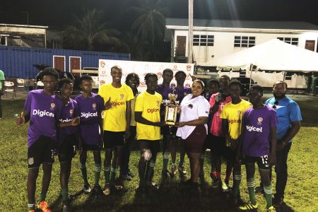 Buxton Secondary captain Omari Edwards collecting the East Coast Demerara zonal title from Petra Organization’s Nareeza Latif in the presence of teammates and members of the coaching staff
