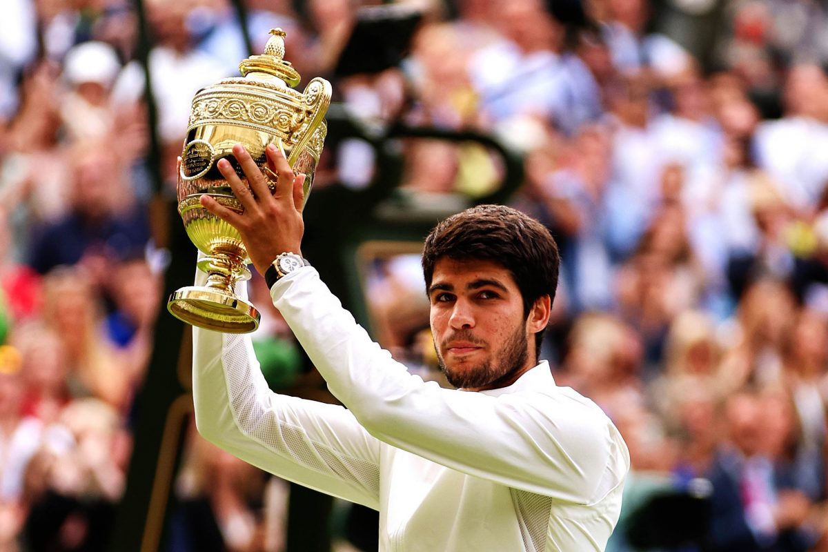 Carlos Alcaraz displaying the Wimbledon Men’s Championship trophy after beating Novak Djokovic in a five set thriller