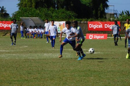 A scene from the round of 32 fixture between DC Caesar Fox (white) and West Demerara in the Digicel Schools Football Championship
