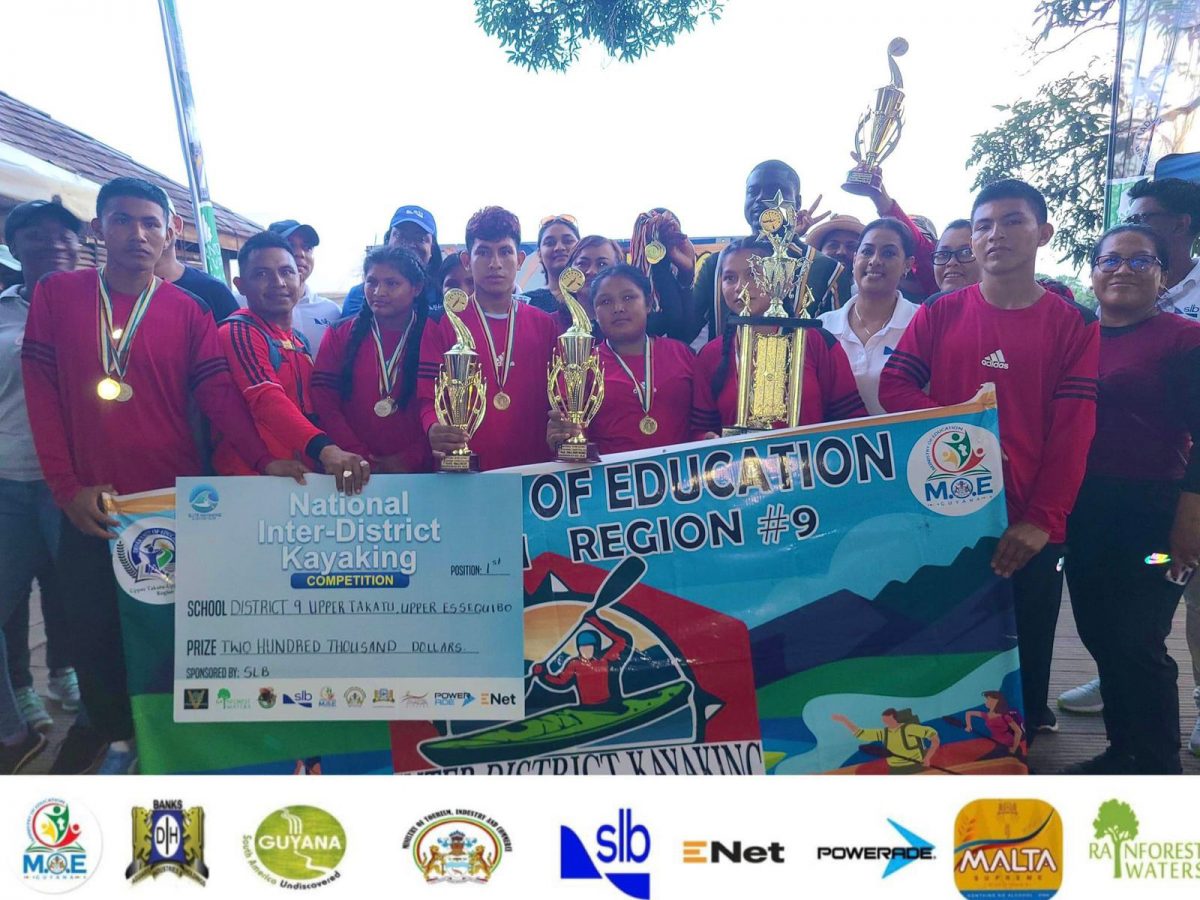 The victorious District 9 outfit Rupununi displaying their spoils after
 winning the National Inter-District Kayaking Competition