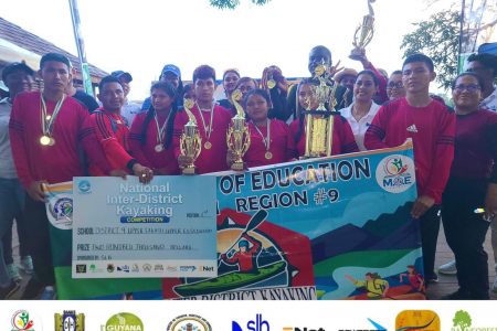 The victorious District 9 outfit Rupununi displaying their spoils after
winning the National Inter-District Kayaking Competition
