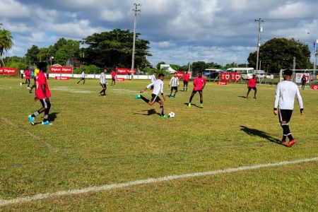 Action in the Waramuri (white) and Vryman’s Erven encounter in the round of 32 section of the Digicel Schools Football Championship
