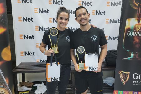 Nicolette Fernandes and Alex Arjoon posing with their spoils after capturing the Women’s and Men’s titles at the Guinness National Squad Championships 