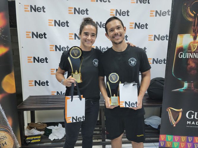 Nicolette Fernandes and Alex Arjoon posing with their spoils after capturing the Women’s and Men’s titles at the Guinness National Squad Championships 