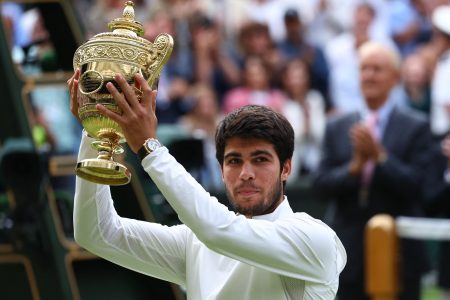 Tennis - Wimbledon - All England Lawn Tennis and Croquet Club, London, Britain - July 16, 2023 Spain's Carlos Alcaraz celebrates with the trophy after winning his final match against Serbia's Novak Djokovic REUTERS/Toby Melville