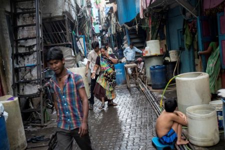 FILE PHOTO: Residents walk in an alley in Dharavi, one of Asia's largest slums, in Mumbai March 12, 2015. REUTERS/Danish Siddiqui/File Photo