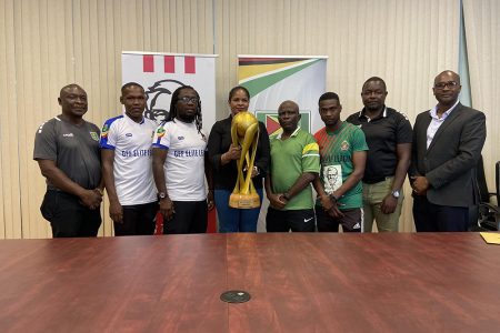 KFC Marketing Manager Pamela Manasseh (centre) posing with
the coveted Elite League trophy while being sandwiched by
members ofthe GDF unit, the GPF outfit and the GFF 