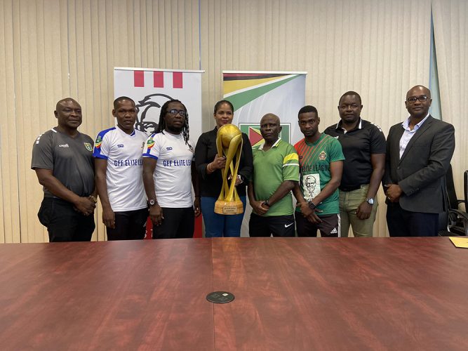 KFC Marketing Manager Pamela Manasseh (centre) posing with
the coveted Elite League trophy while being sandwiched by
members ofthe GDF unit, the GPF outfit and the GFF 