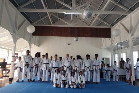 Shuseki Shihan Frank Woon-A-Tai ( 5th from right) 10th Dan and Shihan Amir Khouri (4th from right) 7th Dan sandwiched by the newly promoted Shodans following the end of the Association do Shotokan Karate of Guyana grading examinations
