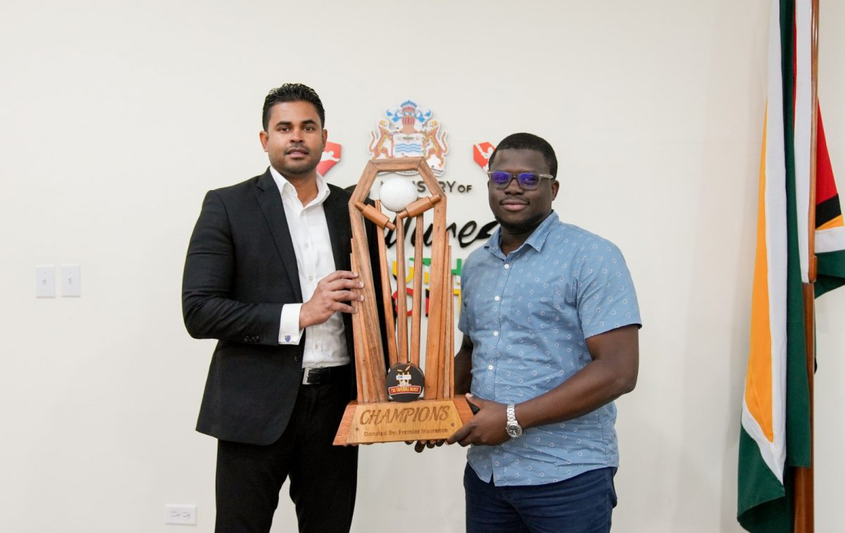 Minister of MCY&S Charles Ramson Jr posing with the championship trophy for the ‘One Guyana’ T10 Tape-ball Blast with co-organizer Akeem Greene

