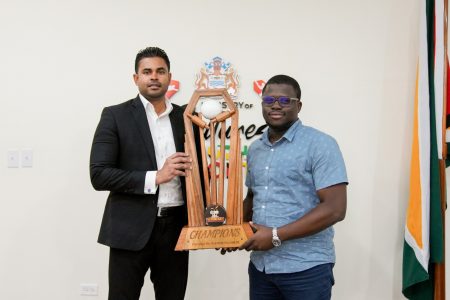 Minister of MCY&S Charles Ramson Jr posing with the championship trophy for the ‘One Guyana’ T10 Tape-ball Blast with co-organizer Akeem Greene
