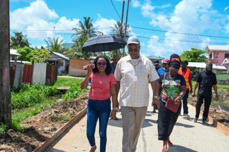 Minister of Public Works, Juan Edghill (second from left), during the walkabout in Sophia. (DPI photo)
