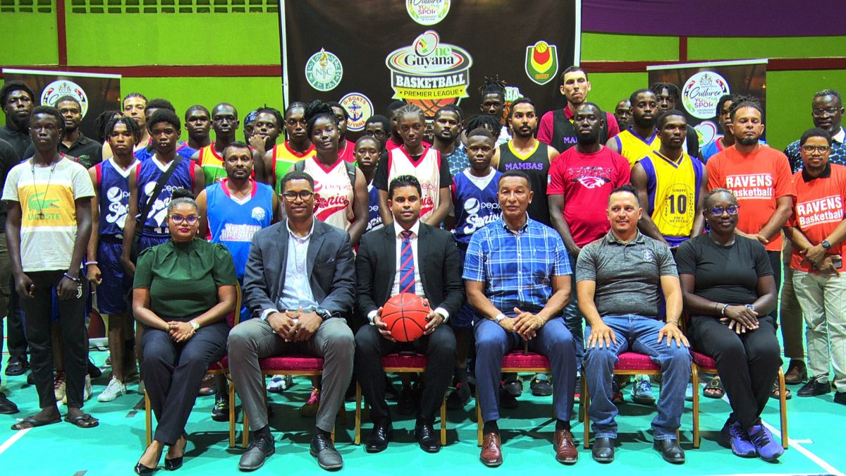 Minister of MCY&S Charles Ramson Jr (centre) surrounded by 
officials from the GBF and GABA as well as players from the representing clubs following the official launch of the ‘One Guyana’ Basketball League  