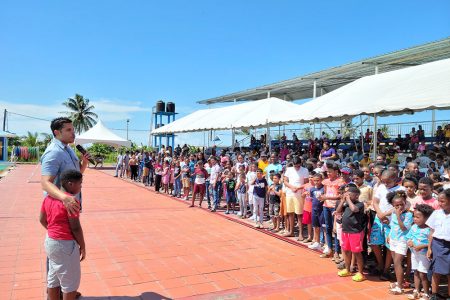 Minster Charles Ramson Jr. addressing the large cadre of participants during yesterday’s launch of the maiden Summer Teach them Young’ Swimming Programme