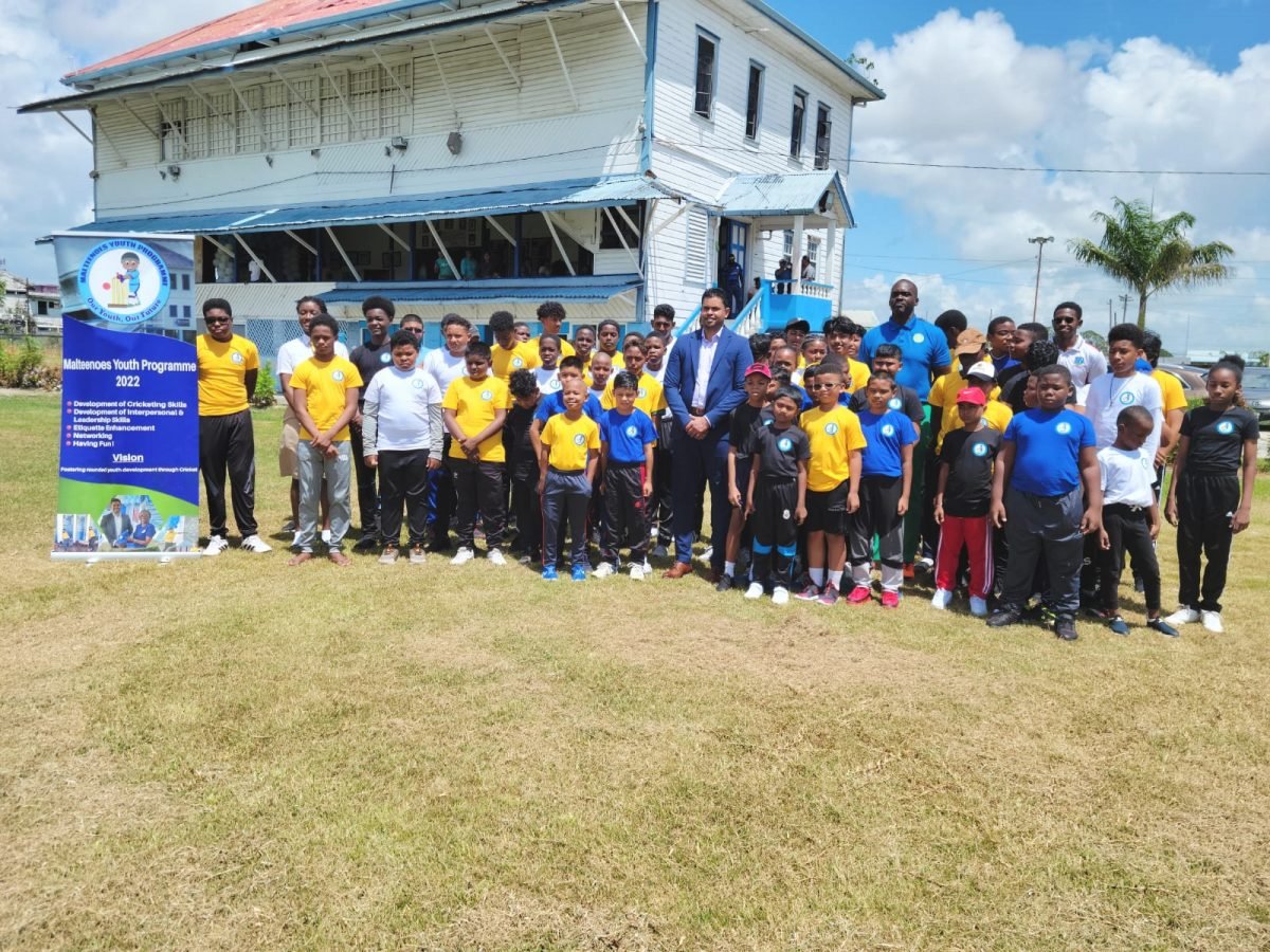 Minister of Culture, Youth and Sport, Charles Ramson Jr with the children of the Malteenoes Cricket Academy
