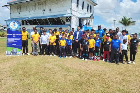 Minister of Culture, Youth and Sport, Charles Ramson Jr with the children of the Malteenoes Cricket Academy
