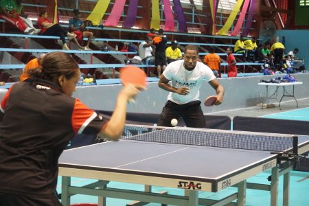 Table-tennis stars Shemar Britton and Chelsea Edghill conducting a training match during the observance of Olympic Day (Emmerson Campbell photos)