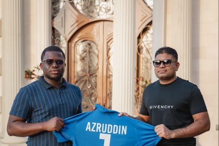 Azruddin Mohamed (right) of Mohamed’s
Enterprise receiving his tournament jersey
from Co-Organizer Akeem Greene while
posing with the championship trophy
