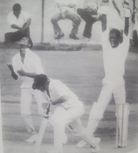 Mike Findlay (arms raised) screams his approval as Sobers calmly flips the ball in the air after catching Terry Jarvis off Inshan Ali in the Fifth Test versus New Zealand (1972) (Photo: 1972 West Indies Cricket Annual)