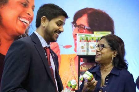 Trinidad and Tobago Guardian Supermarket Association of T&T president Rajiv Diptee shares a light moment with Trade and Industry Minister Paula Gopee-Scoon at Nestle’s booth during the Caribbean Food and Beverage Event at the Centre of Excellence, Macoya