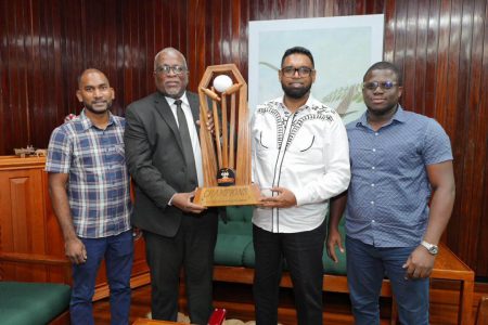 President Dr. Irfaan Ali (second from right), Prime Minister Brigadier (Ret’d) Mark Phillips (second from left) along with co-directors, Yusuf Ali (left) and Akeem Greene display the winner’s trophy