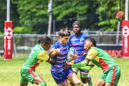 Rugby action involving Guyana (green) and Bermuda yesterday at the Mona Campus in Jamaica
