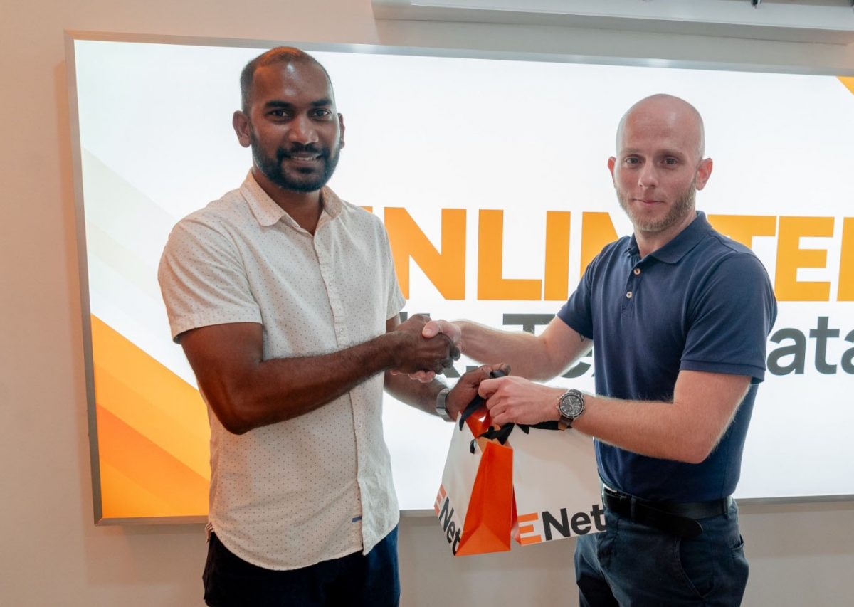 Co-Director of Kares One Guyana T10 Blast, Yusuf Ali (left), collects the two cellphones from Robert Hiscock, Head of Mobile Networks at ENet