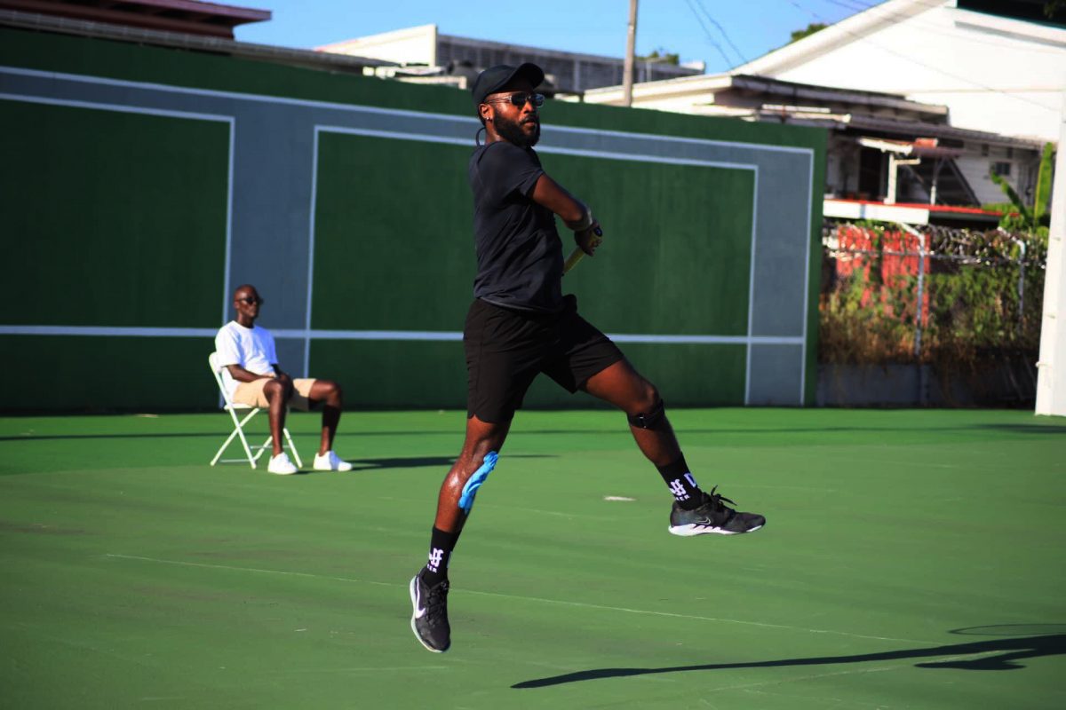 Gavin Lewis unleashing a powerful forehand stroke against Phillip Squires in the final of the Men’s Open Division