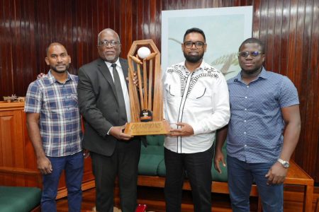 President  Irfaan Ali (second from right), Prime Minister Brigadier (Ret’d) Mark Phillips (second from left)
along with co-directors, Yusuf Ali (left) and Akeem Greene display the winner’s trophy